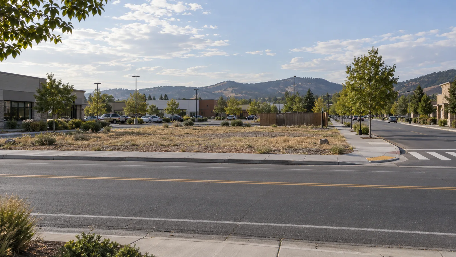 A compact vacant outparcel on a frontage road, before a restaurant proposal